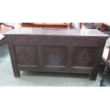 18th CENTURY CARVED OAK COFFER with 3 panelled front, carved motifs, rising top with later hinges,