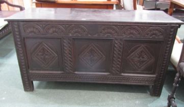 18th CENTURY CARVED OAK COFFER with 3 panelled front, carved motifs, rising top with later hinges,