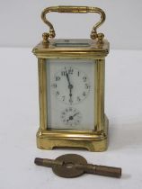 MINIATURE BRASS CARRIAGE CLOCK with white enamel face and secondary dial, 7cm height with key