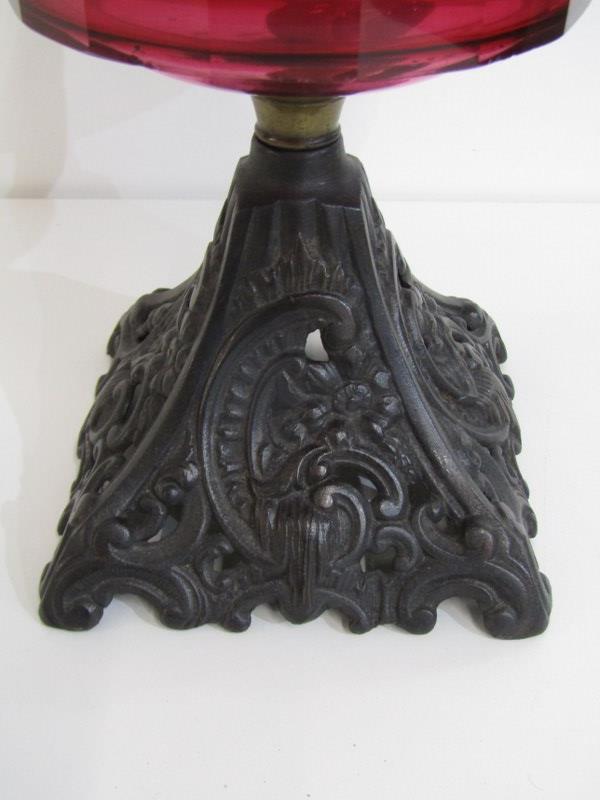 LATE VICTORIAN OIL LAMP, with cast iron foliate decorated base and red glass reservoir, 57cm - Image 3 of 3