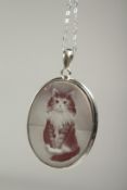 A silver cameo cat pendant and chain in a box.