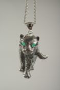 A silver Deco style panther pendant and chain in a box.