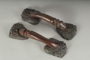 A PAIR OF BRONZE EROTIC DOOR HANDLES. 12ins long.