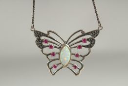A silver opal ruby butterfly pendant and chain in a box.