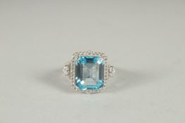 A SILVER BLUE TOPAZ AND C Z RING.
