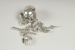 A cast silver skull watch chain and snuff box.
