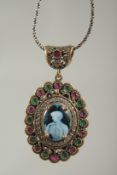 A silver gilded ruby set cameo pendant and chain in a box.