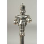 A silver novelty soldier rattle.