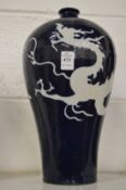 A Chinese blue glazed Meiping vase decorated with a dragon.