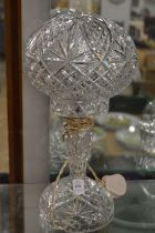 A cut glass table lamp.