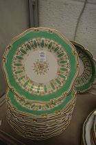 A group of Worcester Granger & Co gilt decorated green ground plates and matching comport.