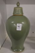 A Chinese celadon glazed baluster shaped vase and cover.