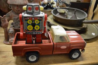 A Japanese clockwork robot and a Tonka Toy pickup truck.