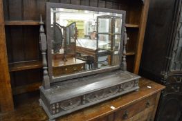 An oak dressing table mirror with three drawers.