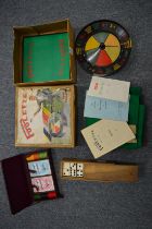 A boxed Poolette roulette style game together with bone and ebony dominoes and boxed set of