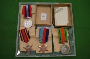 A set of four World War II medals, unnamed.