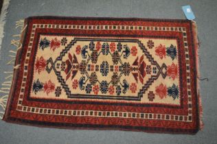 A small Persian rug 117cm x 76cm.