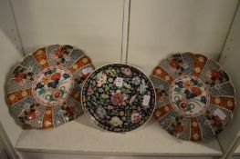 A pair of Imari dishes and famille noire circular dish.