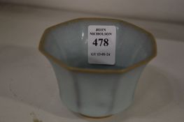 A small celadon glazed octagonal shaped bowl.