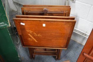 An unusual set of four folding occasional tables decorated with bamboo.