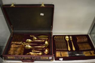 A fitted case containing a canteen of bronzed cutlery.