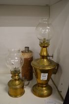 Two small brass hand held oil lamps.