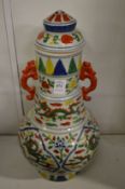 A large Chinese polychrome decorated baluster shaped vase and cover.