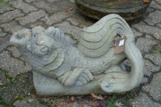A pair of reconstituted stone dolphin fountains.