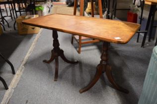 A Lloyd Loom linen basket, mahogany coffee table and a wooden stand.