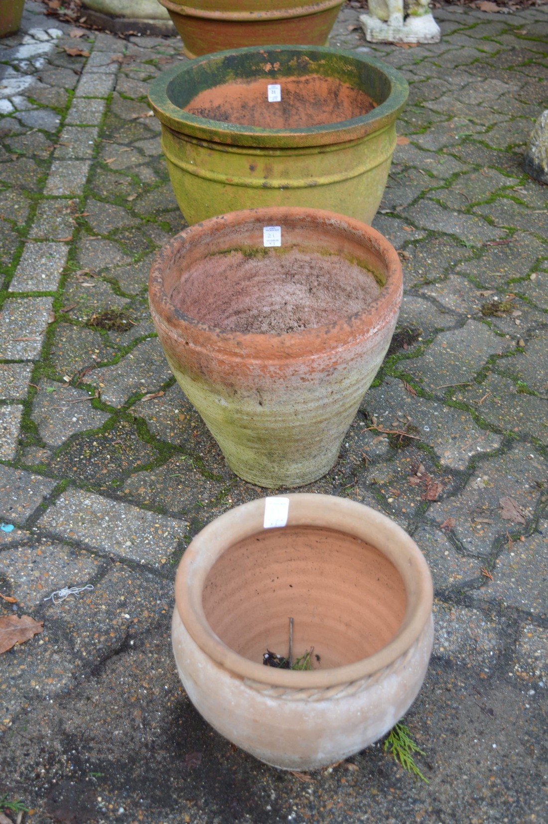 Three terracotta plant pots.