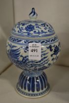 A Chinese blue and white pedestal bowl and cover.