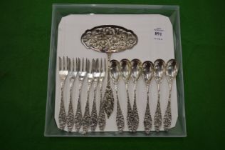 A set of six Continental silver spoons with matching forks and a serving spoon.