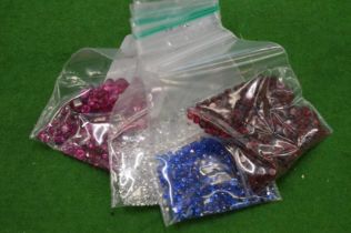 Various bags of coloured spinels.