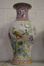A Chinese famille rose vase decorated with exotic birds.