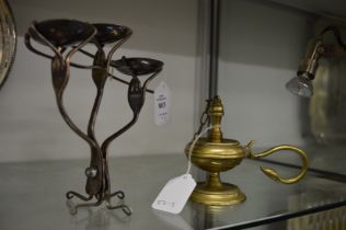 An unusual candle stand made from old forks and spoons together with a brass oil lamp.