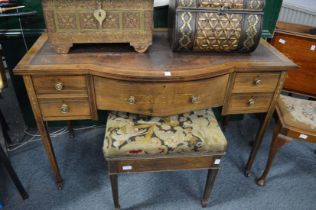 An Edwardian inlaid mahogany bow fronted writing table.