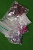 Various bags of coloured spinels.