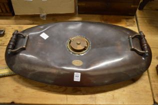 A large copper twin handled warming pan.