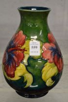 A Moorcroft baluster shaped vase decorated with flowers.