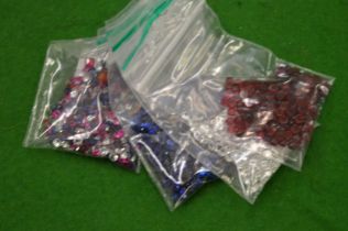 Various bags of coloured spinels.