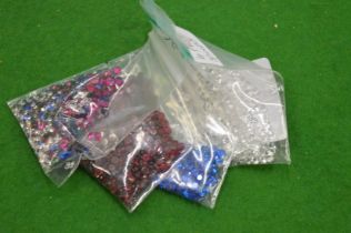 Various bags of coloured spinels.