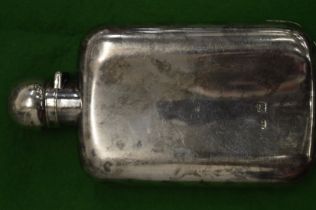 A silver hip flask.