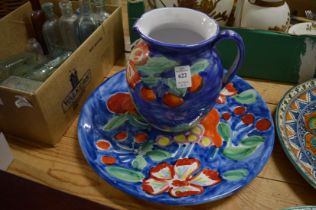 A colourfully painted jug and dish.