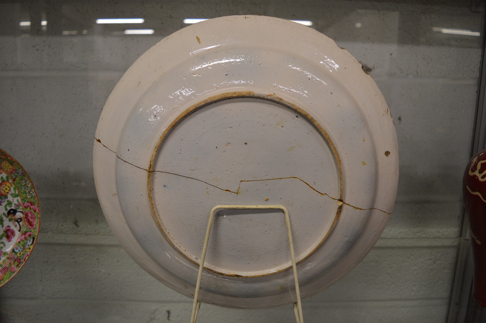 An early polychrome decorated tin glazed circular dish (faults). - Image 2 of 2