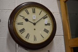 A mahogany cased circular wall clock.