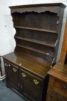 A small dark oak dresser.