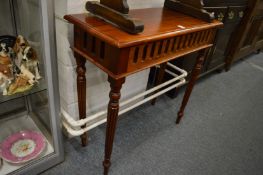 A mahogany stained side table on turned and reeded legs.