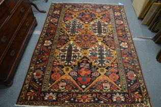 Persian design carpet with all-over stylised colourful floral decoration 206cm x 147cm.