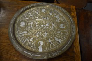 An Egyptian circular brass tray with inlaid decoration.