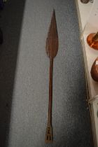 An African carved wood spear shaped paddle.